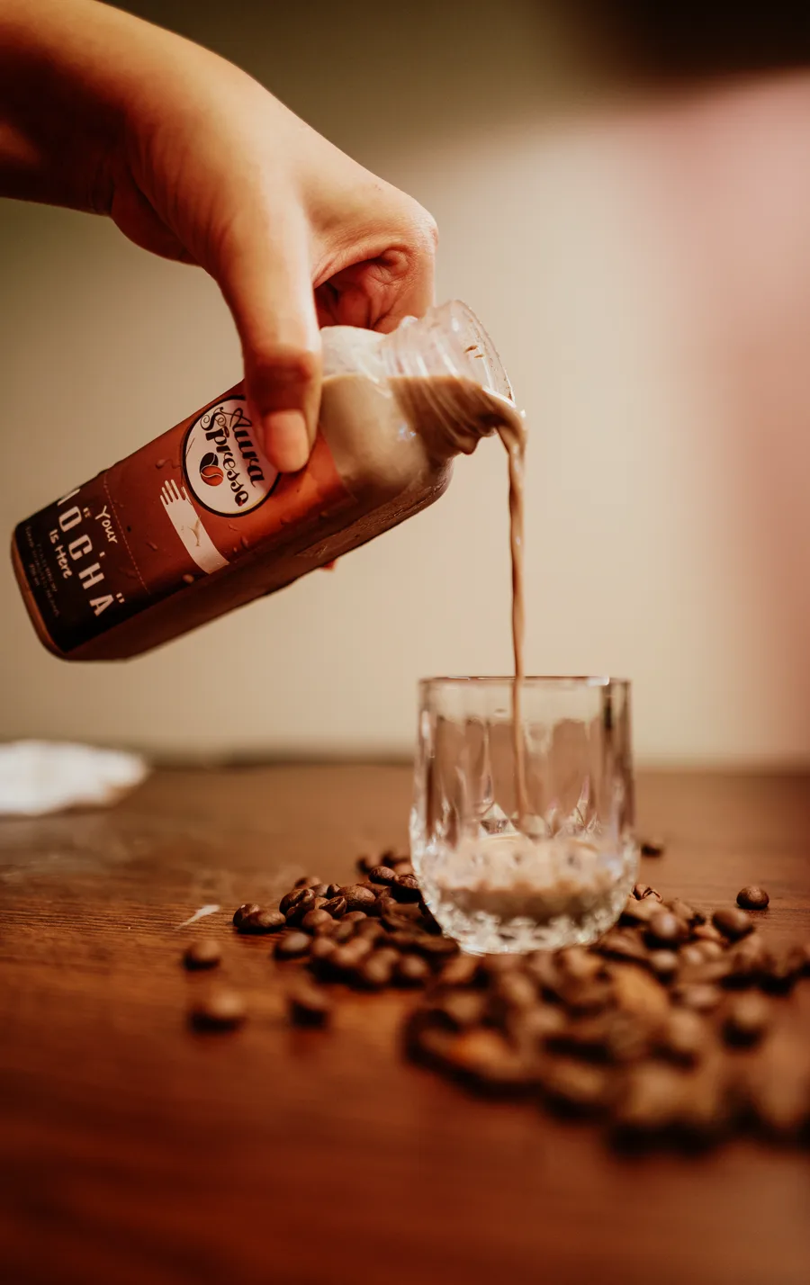 AuraSpresso mocha bottle pouring into a glass
